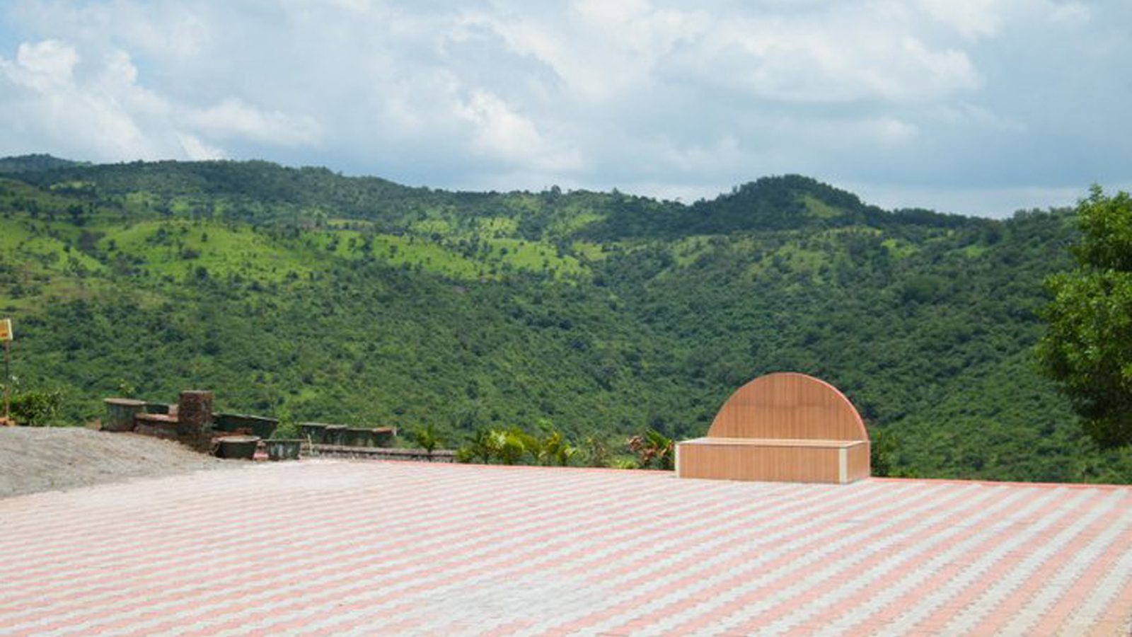Hilltop terrace at Anandkunj with green hills in the distance