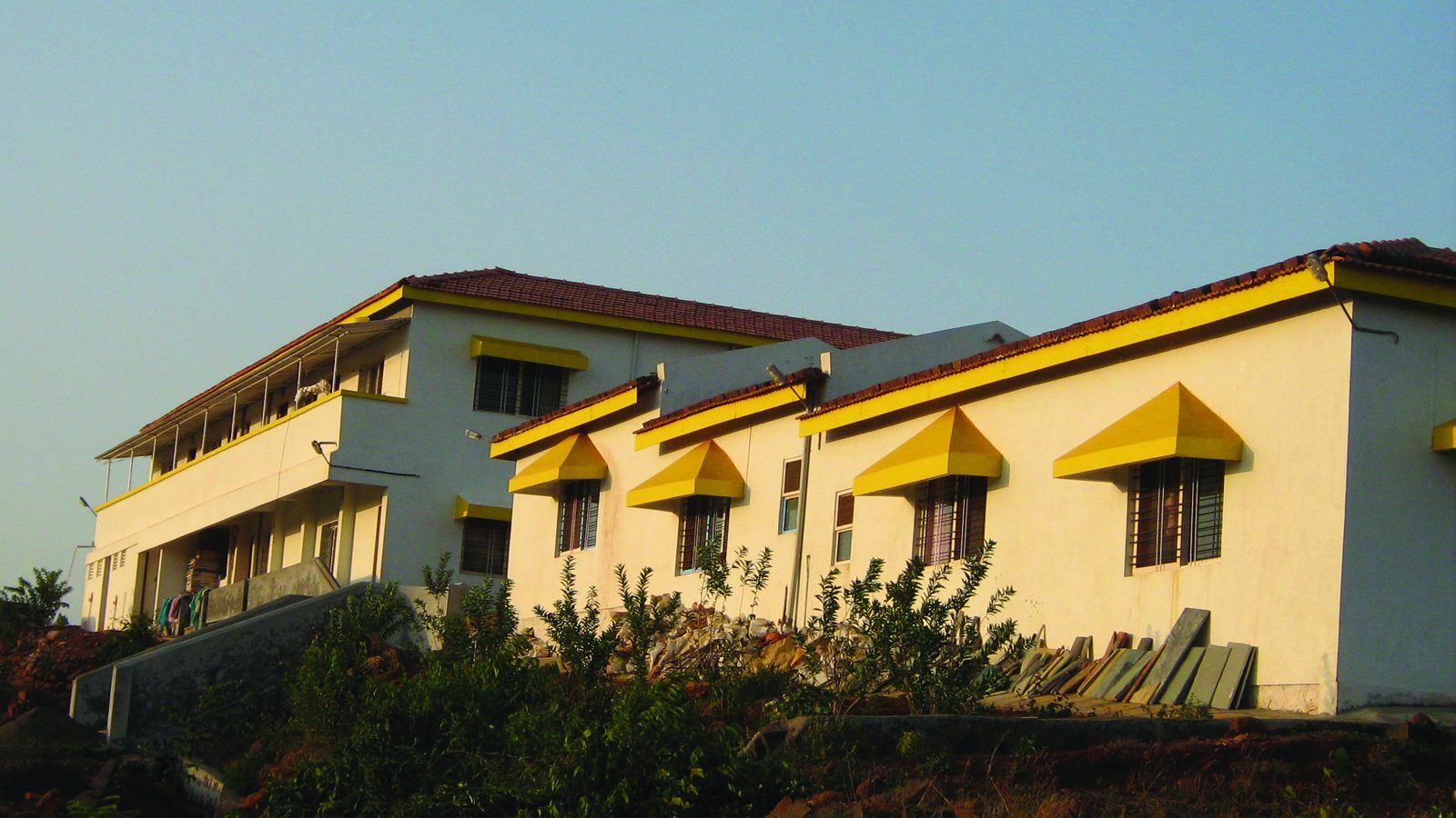 Cream-coloured building with yellow awnings at the Anandkunj campus