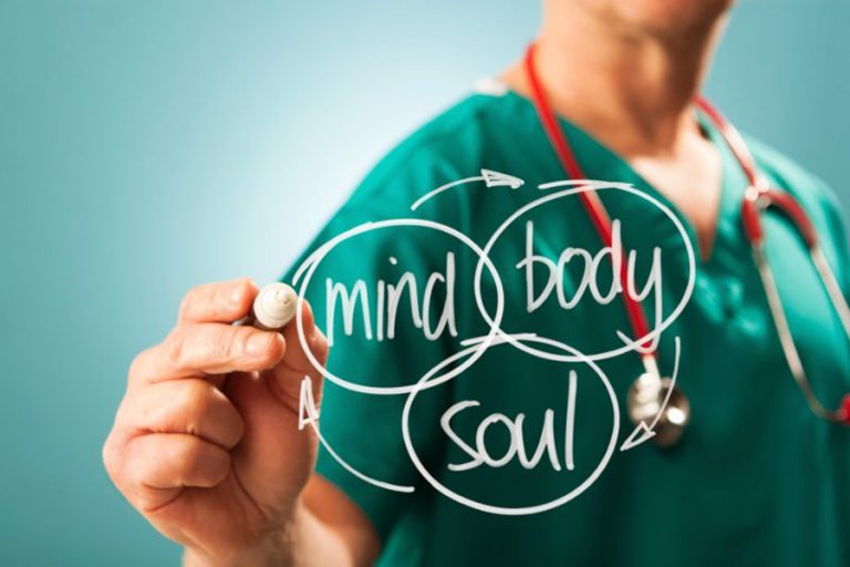 Doctor writing the words mind, body and soul